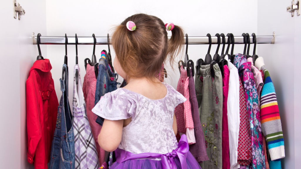 Children selecting clothes from their wardrobe, excited about their choices for the photo session.