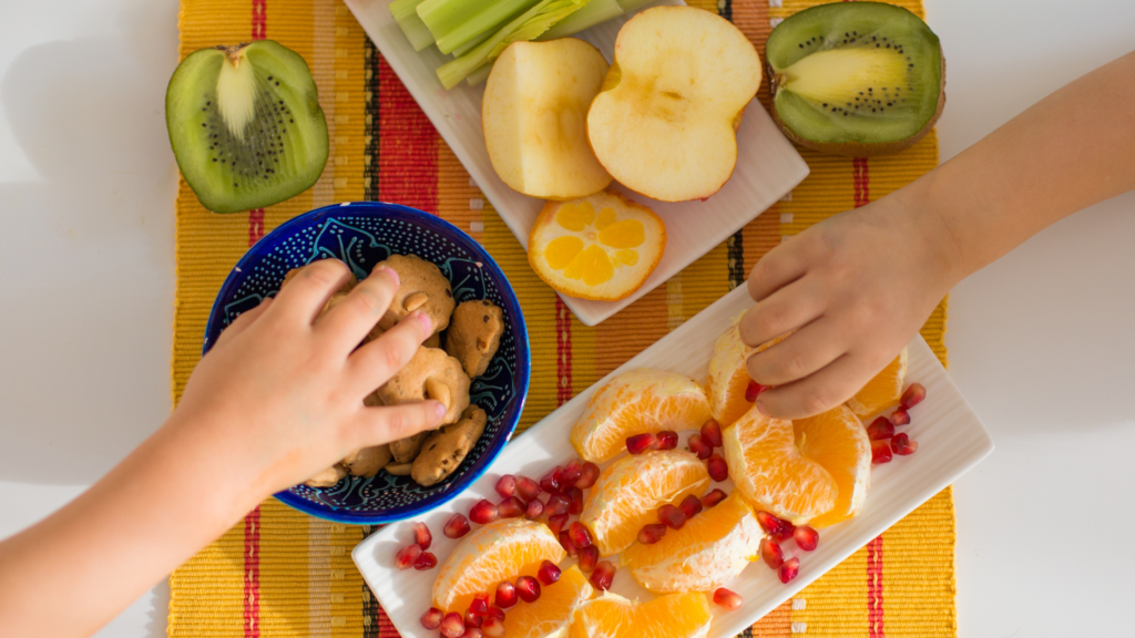 A young child enjoying a healthy snack before a family photo session to ensure they are well-fed.