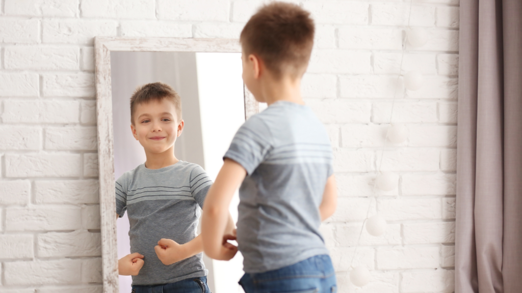 A family practicing poses and smiling in front of a mirror to prepare for their photo session. 