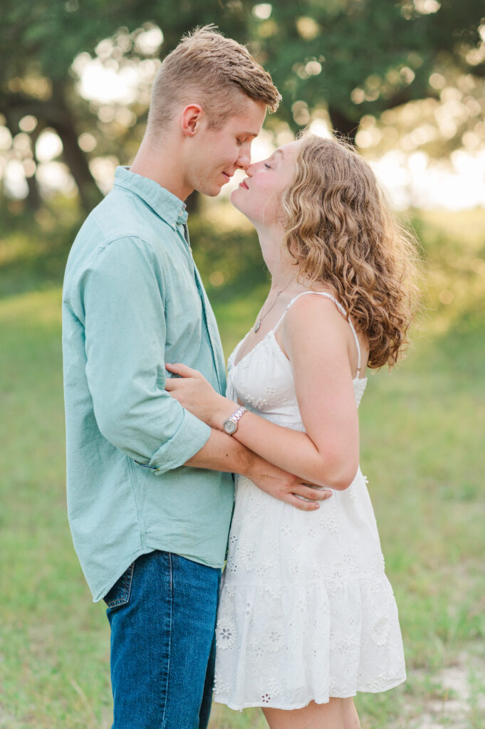 Romantic close-up portrait of an engaged couple sharing an intimate moment during golden hour on Florida's Emerald Coast.